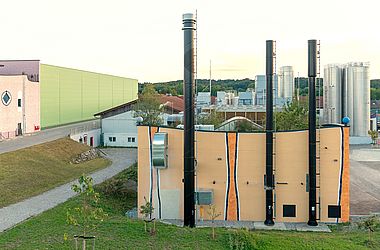 Energy centre with CHP chimney on the left and two boilers